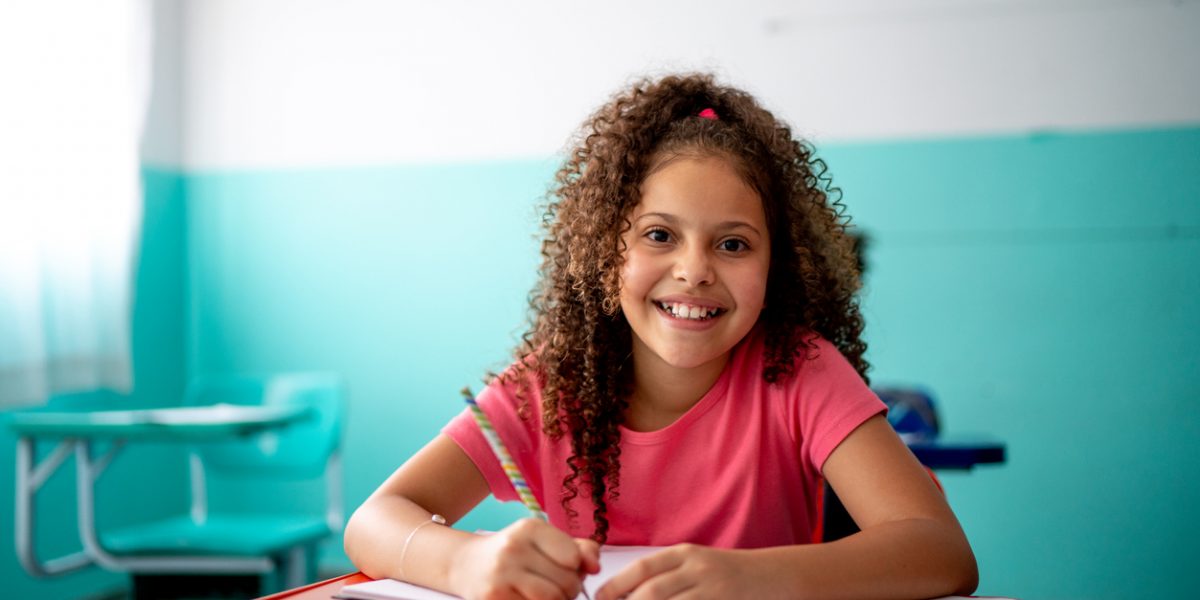 Portrait of a girl taking notes in the classroom